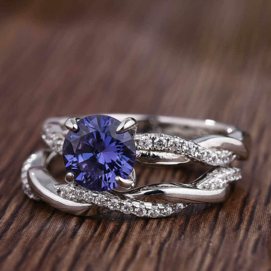 Silver ring with a blue gemstone on a wooden surface