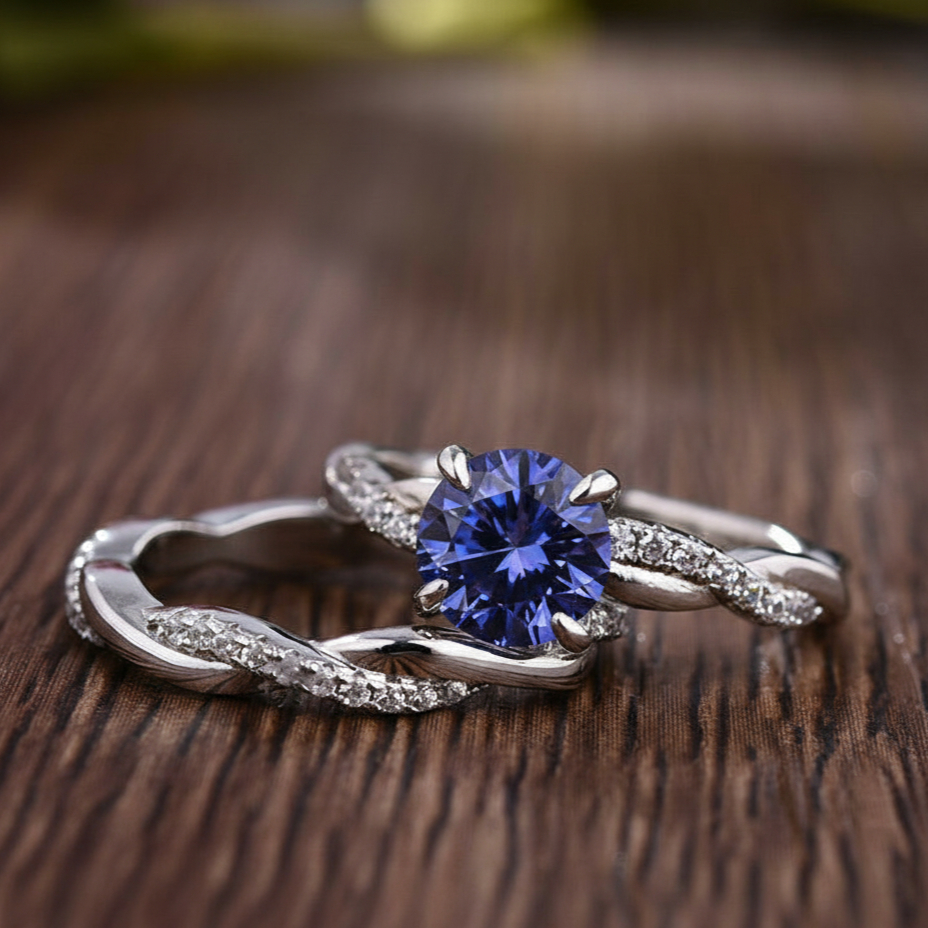 Silver ring with a blue gemstone on a wooden surface