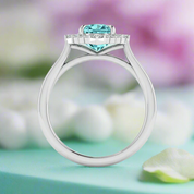 Silver ring with a heart-shaped blue gemstone on a white background