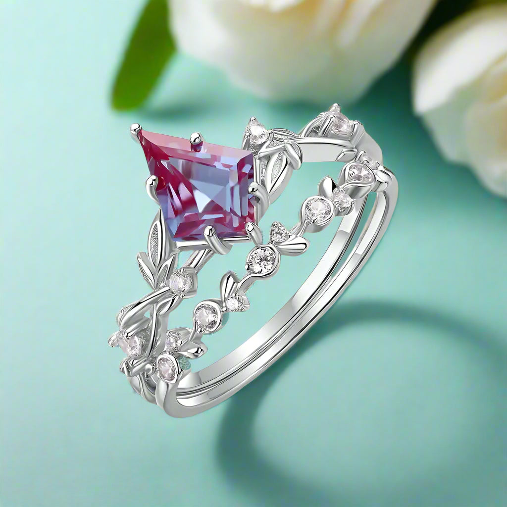 Silver ring with a pink gemstone on a white background