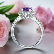Silver ring with a purple gemstone and diamond accents on a white background