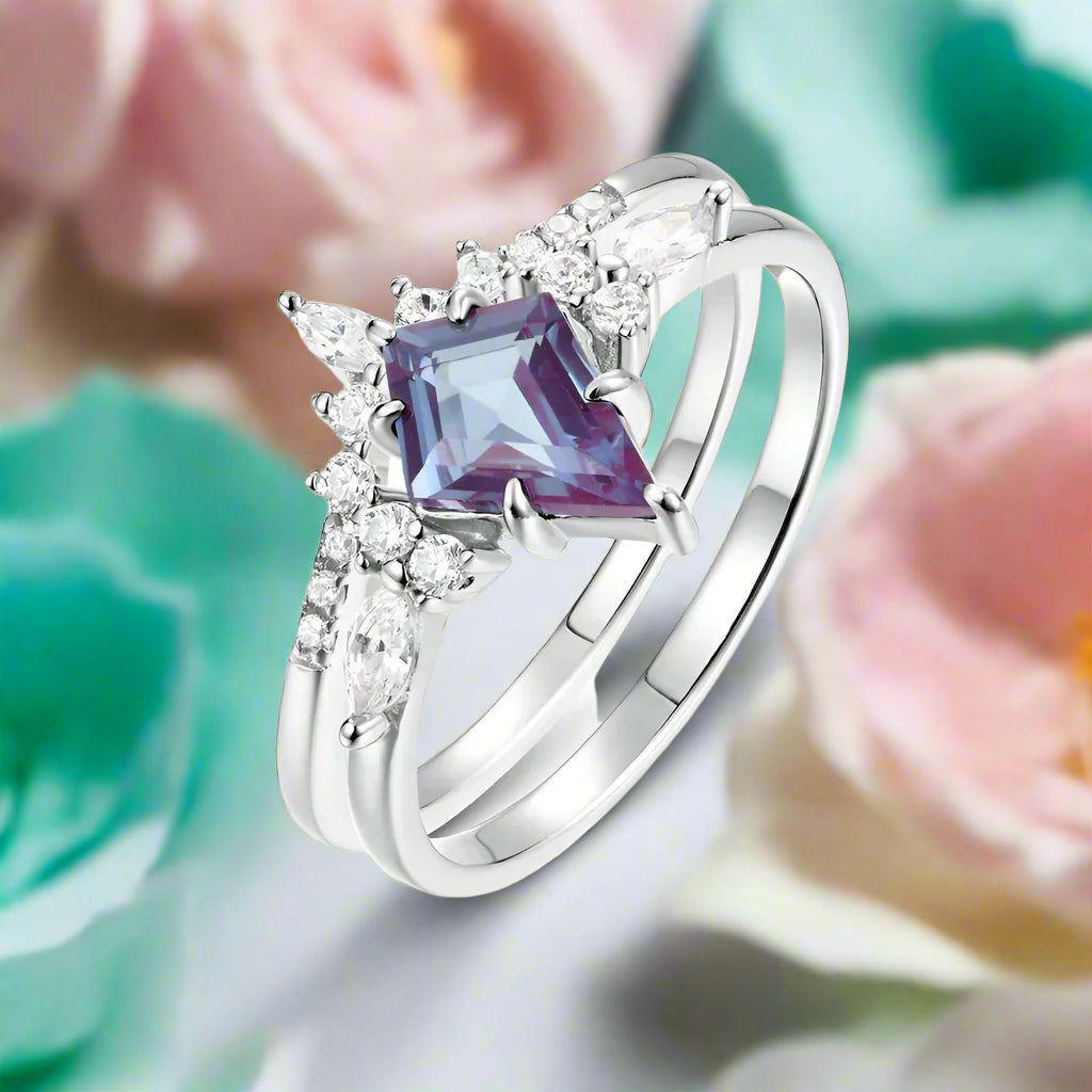 Silver ring with a purple gemstone and diamonds on a white background 
