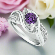 Silver ring with a purple gemstone and smaller diamonds on a white background