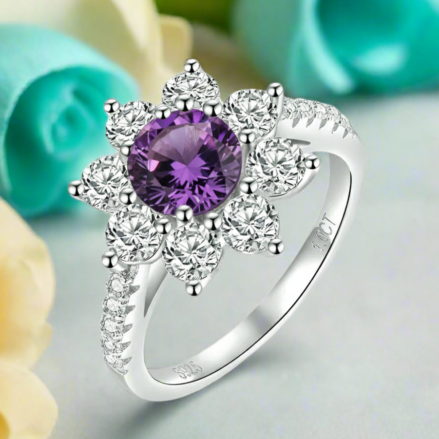 Silver ring with a purple gemstone on a light background