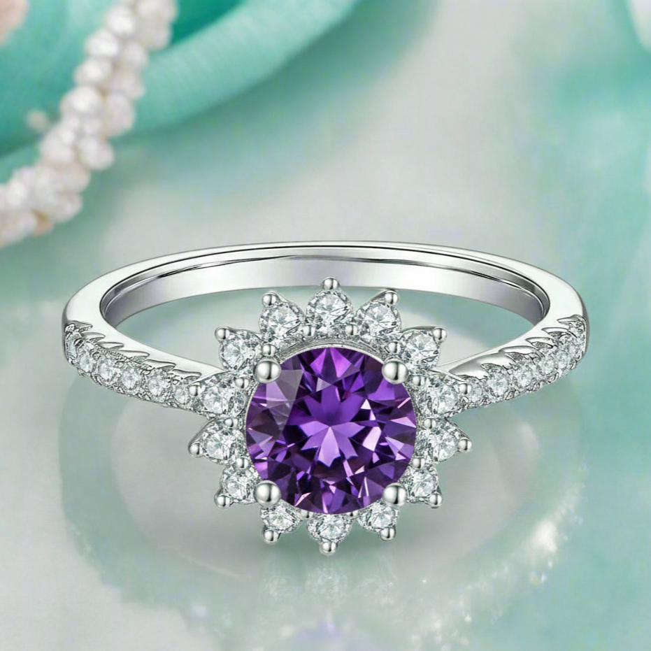 Silver ring with a purple gemstone on a light green background