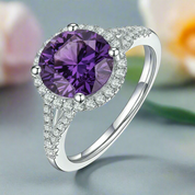 Silver ring with a purple gemstone on a white background