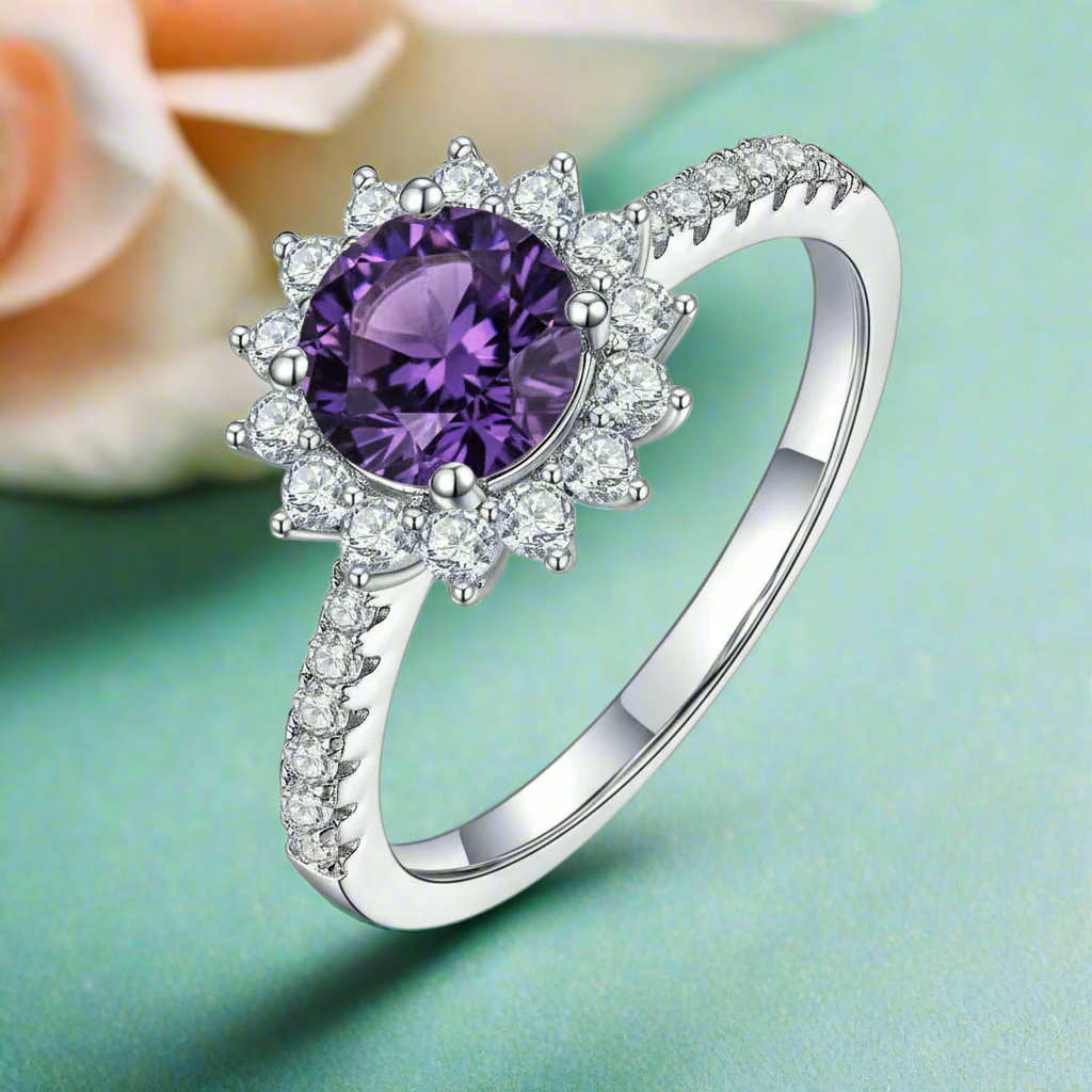 Silver ring with a purple gemstone on a white background