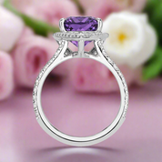 Silver ring with a purple gemstone on a white background