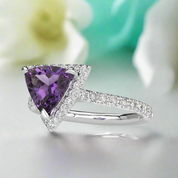 Silver ring with a purple gemstone on a white background