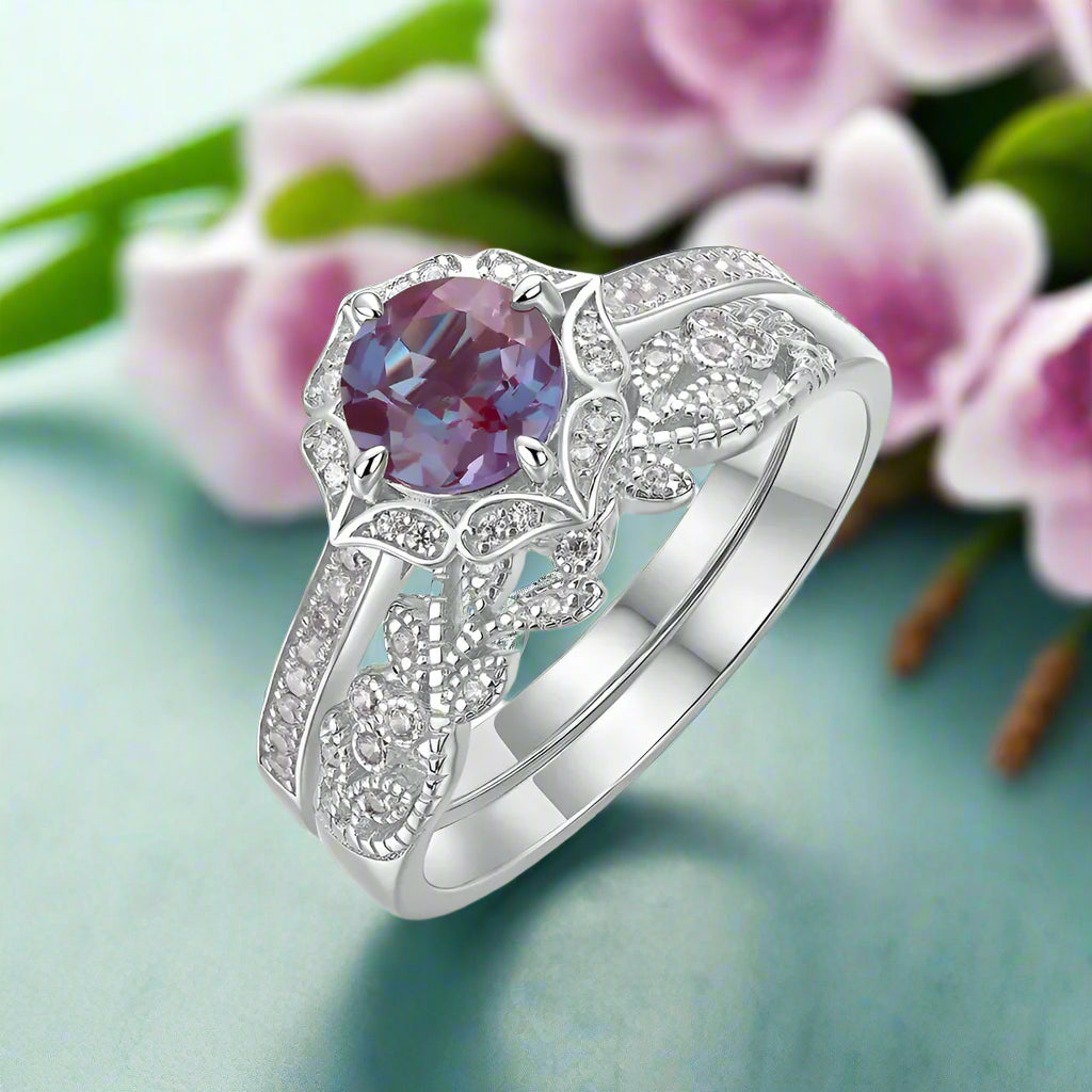 Silver ring with a purple gemstone on a white background