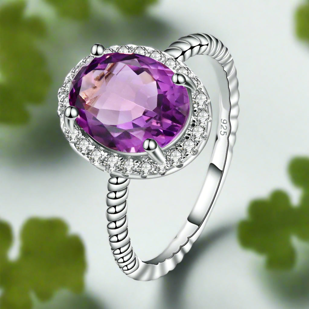 Silver ring with a purple gemstone on a white background