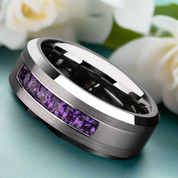 Silver ring with purple gemstones on a dark background