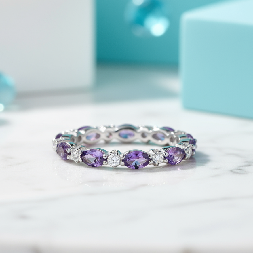 Silver ring with purple gemstones on a light blue background