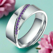 Silver ring with purple gemstones on a white background
