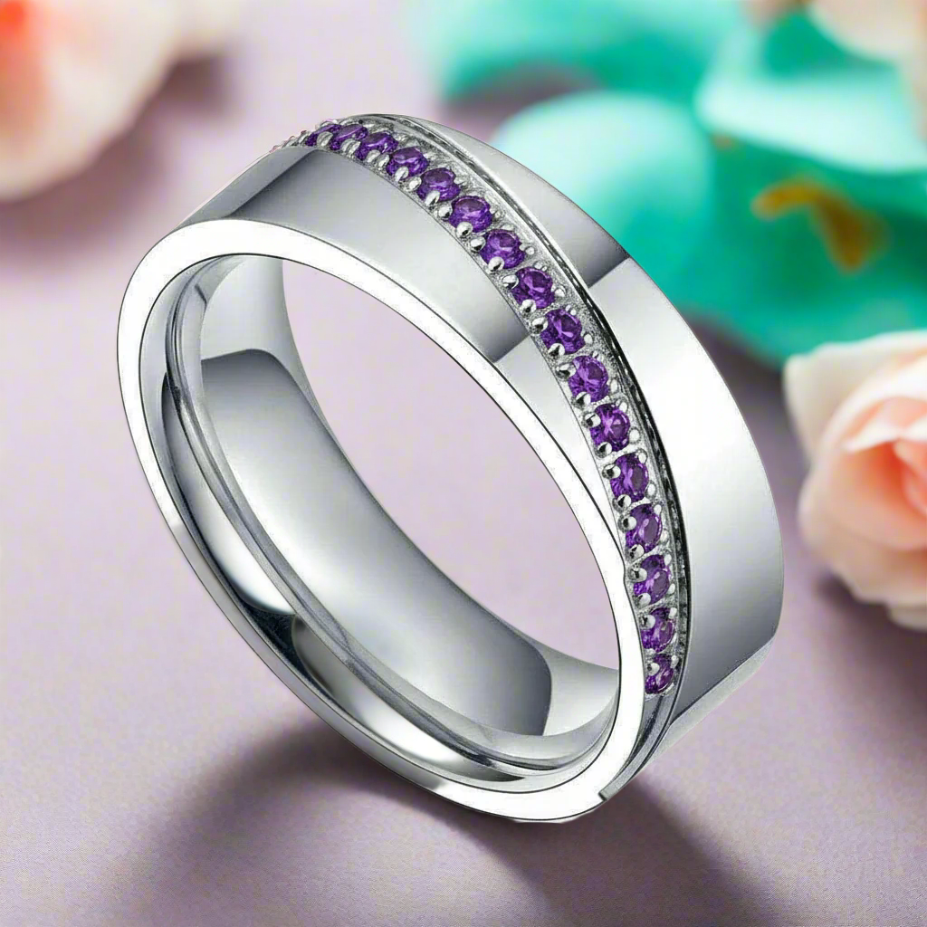 Silver ring with purple gemstones on a white background