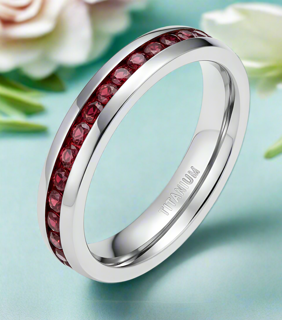Silver ring with red gemstones on a white background