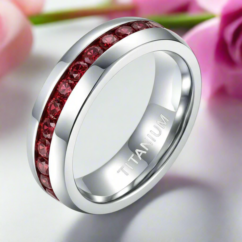 Silver ring with red gemstones on a white background