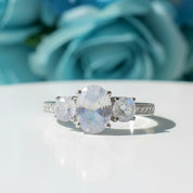 Silver ring with three moonstone gemstones on a white background