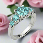 Silver ring with turquoise gemstones on a white background