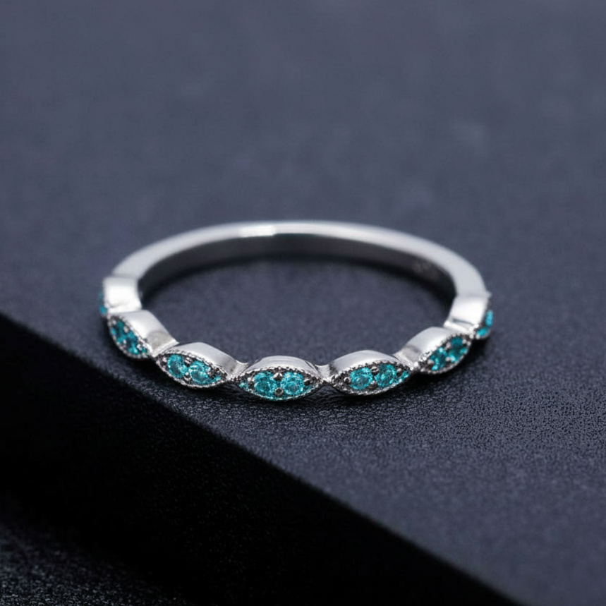 Silver ring with turquoise stones on a dark background