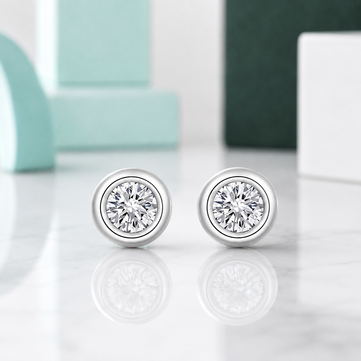 Silver stud earrings with clear gemstones on a light gray background