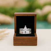 Stack of rings in a wooden box with a blurred natural background
