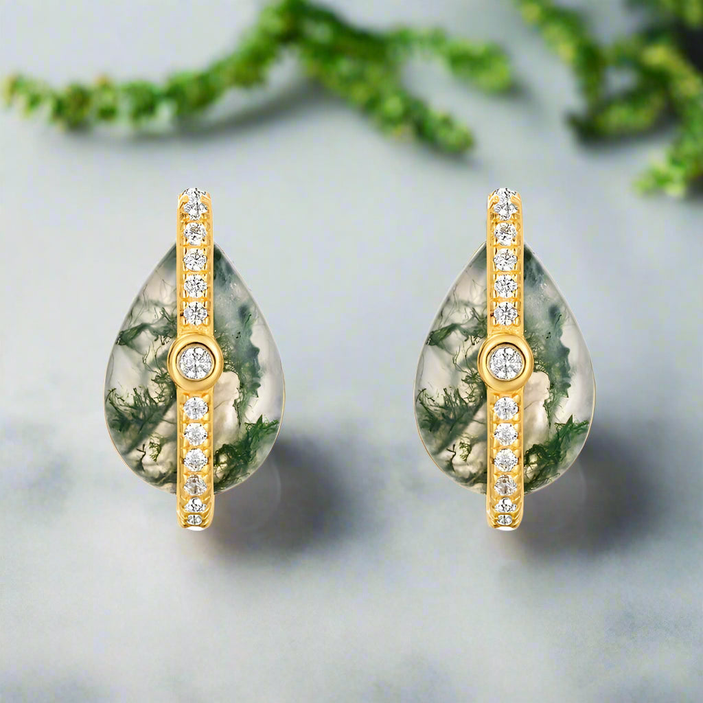Teardrop-shaped earrings with gold and gemstone details on a white background