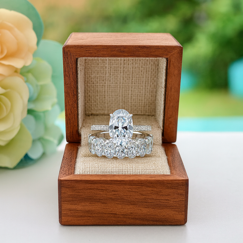 Two diamond rings in a wooden box with flowers in the background