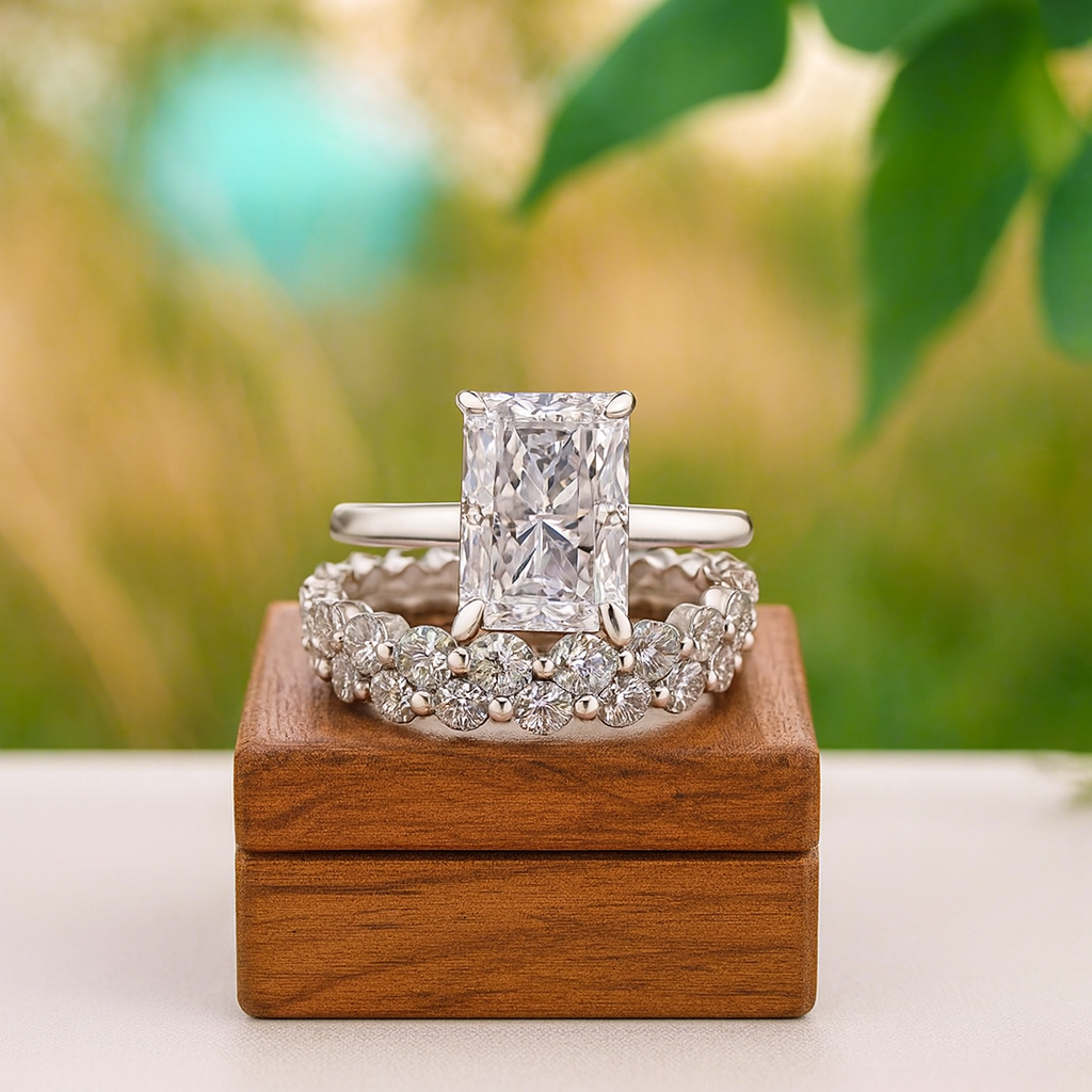 Two diamond rings on a wooden box with a blurred natural background