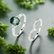 Two silver rings with green gemstones on a white background
