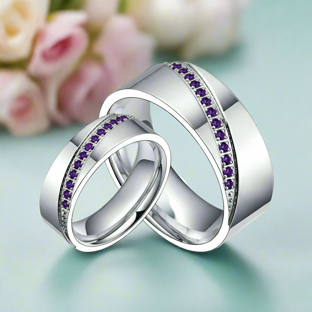 Two silver rings with purple gemstones on a light green background