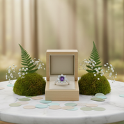 Wooden box with a ring on a marble table in a forest setting