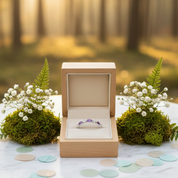 Wooden ring box with a ring on a marble table in a forest setting