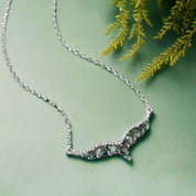 Necklace with green gemstones on a white background