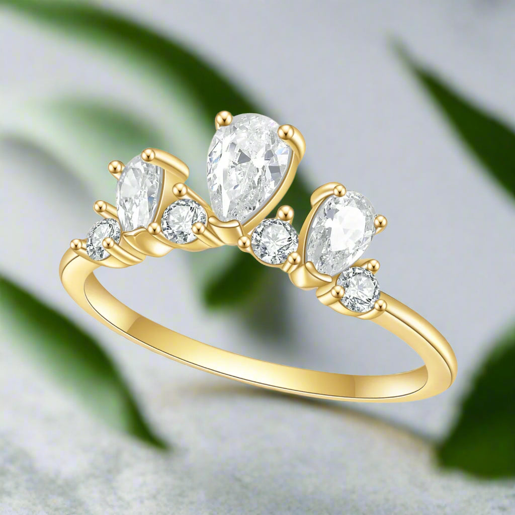 Gold ring with clear gemstones on a white background